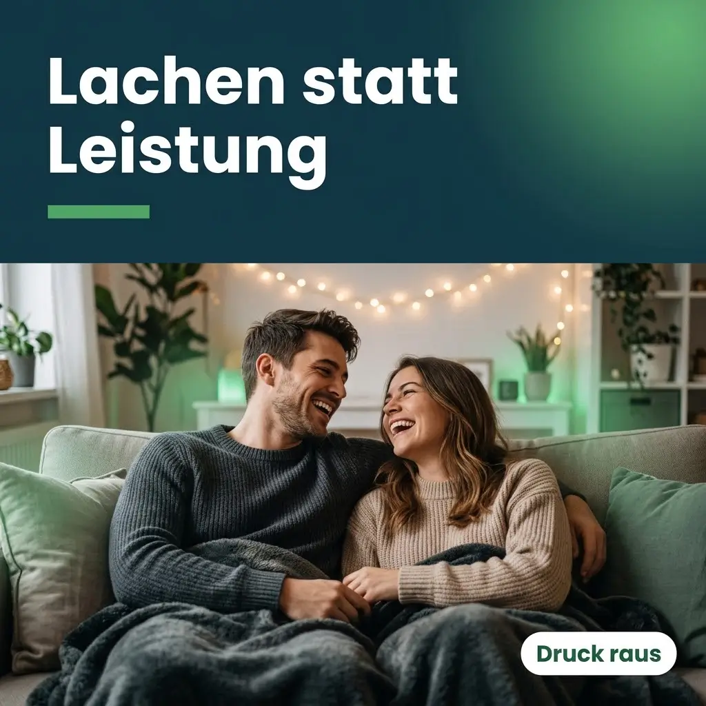 Junges Paar liegt lachend unter einer Decke auf dem Sofa